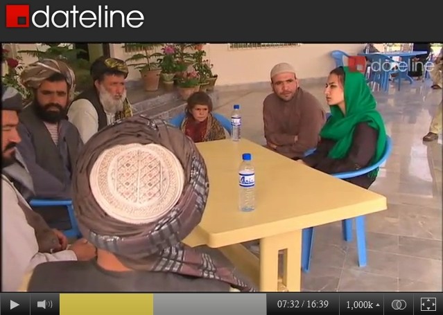 A screen-captured group image of survivors of the March 11, 2012 Panjwai Massacre being interviewed by SBS-TV reporter Yalda Hakim, at a military base hospital in Afghanistan